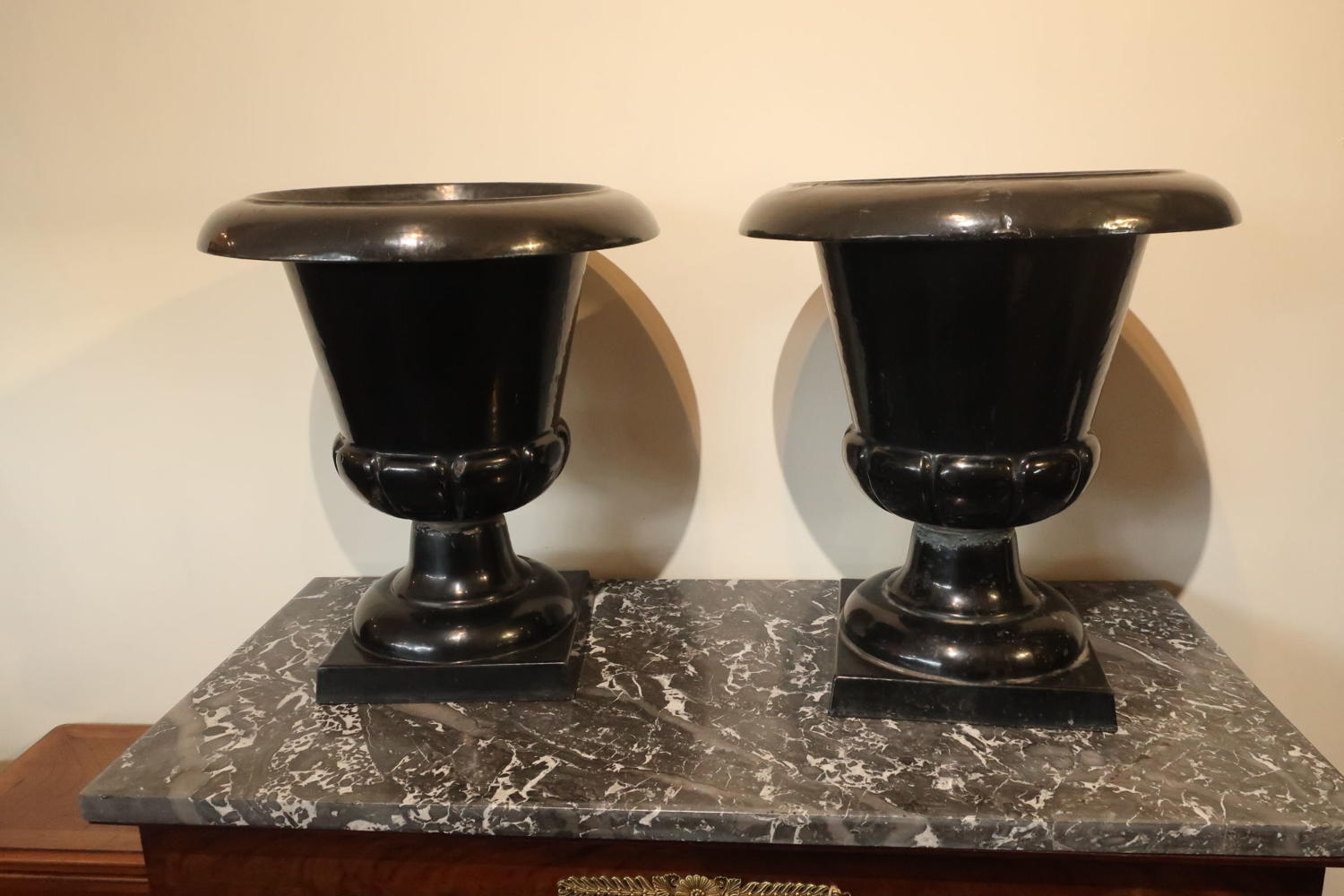 Pair of black enamelled garden urns