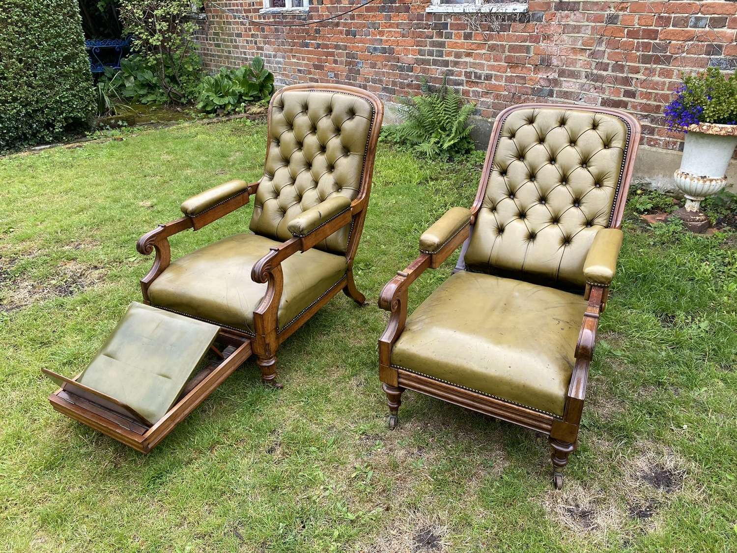Matched pair of patent reclining armchairs in green leather