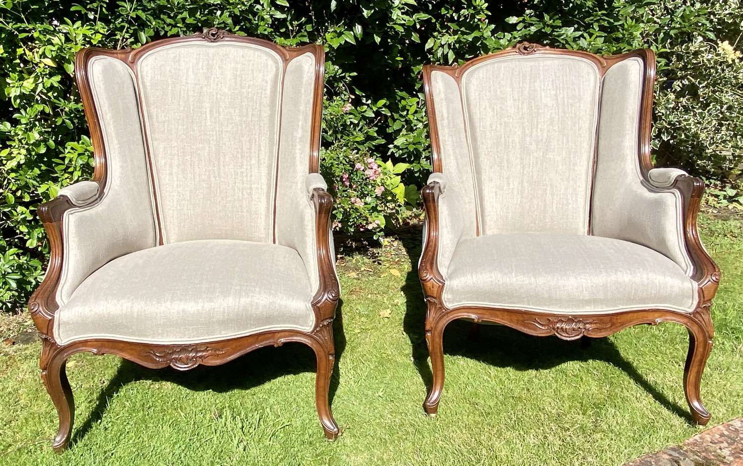 Large pair of French carved walnut armchairs