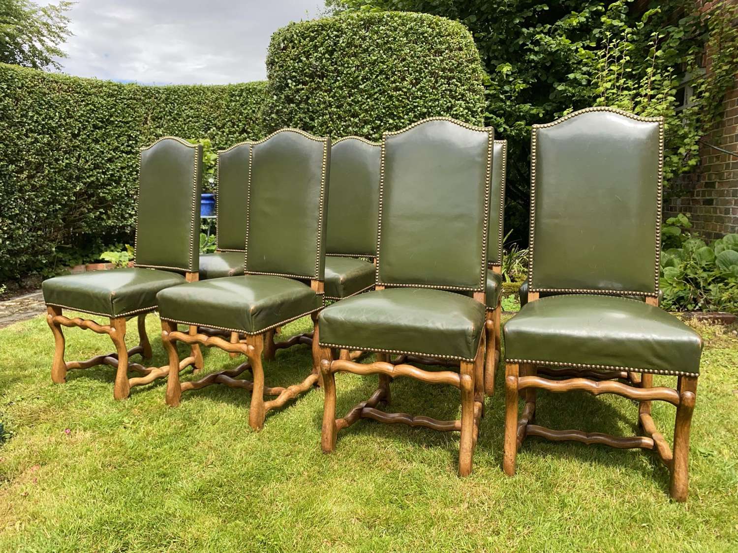 Set of 8 green leather dining chairs