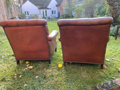 Pair of button back leather armchairs