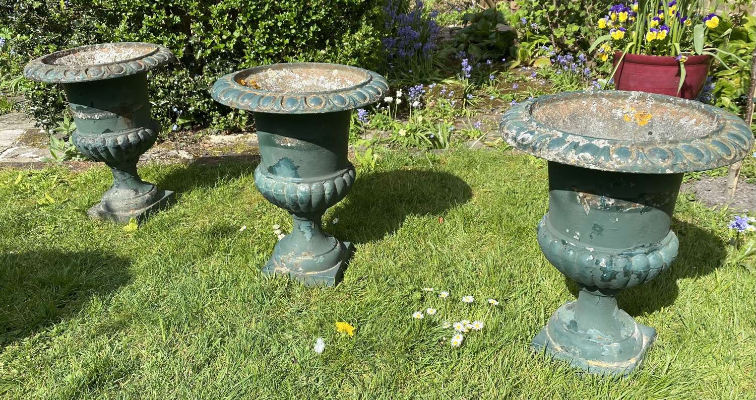 Set of three cast iron garden urns