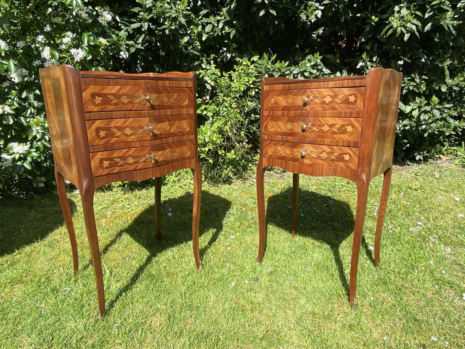 A pair of marquetry bedside tables