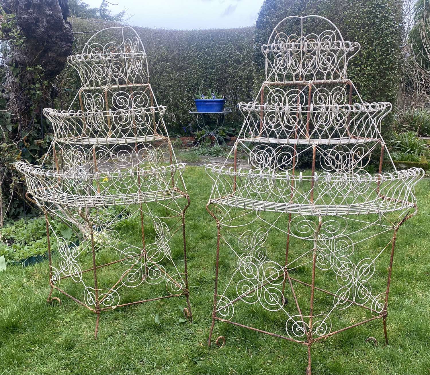 A pair of painted wire work plant stands