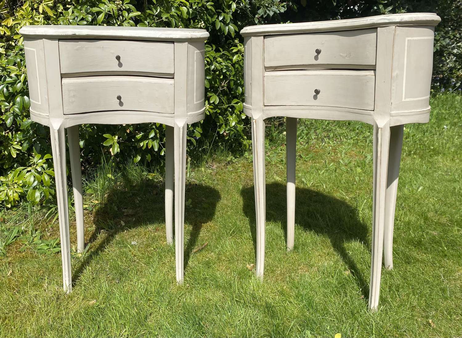 Pair of painted kidney shaped bedside tables