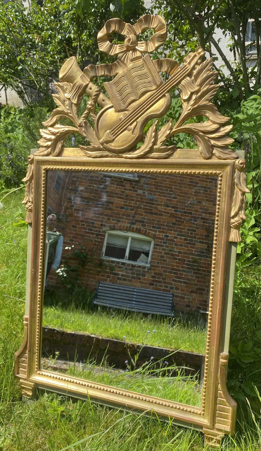 Pretty gilt and painted mirror with musical motifs