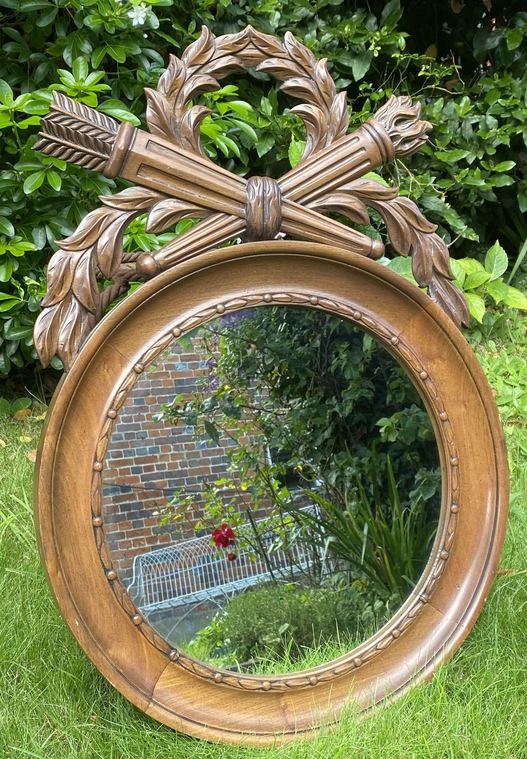Carved round mirror with cresting