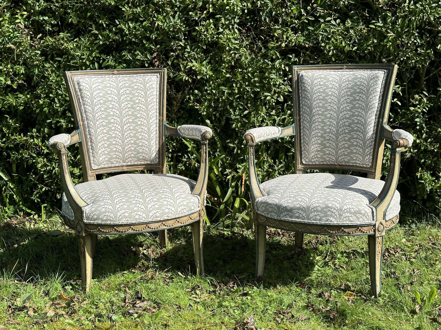 A Pair Of French Neoclassical Open Arm Chairs