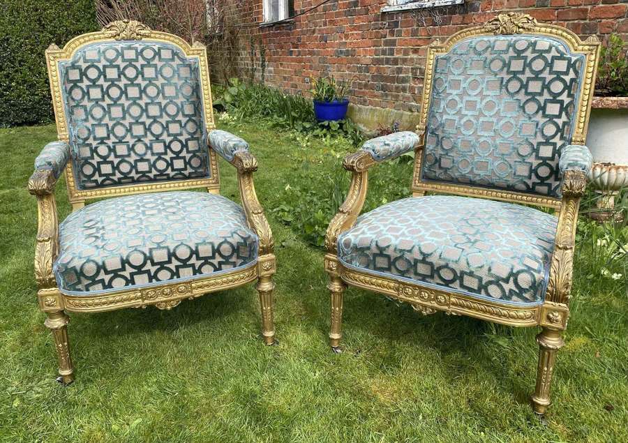 A pair of large gilt armchairs