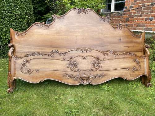 Carved walnut super king bed