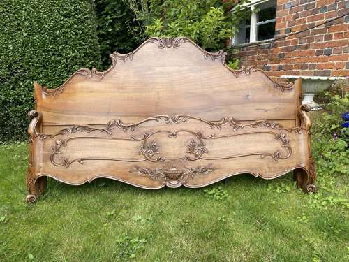 Carved walnut super king bed